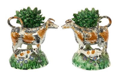Lot Rare pair of pearlware pottery cow creamers, collection labels to underside