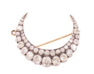 Lot A fine Victorian diamond crescent pendant/brooch with a double row of graduated old cut diamonds in silver collet setting, pierced gold gallery with hinged pendant fitting and detachable brooch...