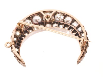 Lot 550 - A fine Victorian diamond crescent pendant/brooch with a double row of graduated old cut diamonds in silver collet setting, pierced gold gallery with hinged pendant fitting and detachable brooch...