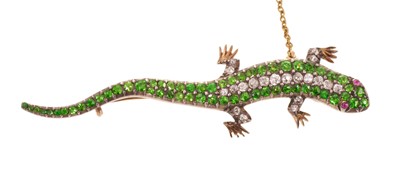 Lot Victorian demantoid green garnet and diamond lizard brooch with pavé set body and ruby cabochon eyes, in silver and gold setting, 59mm.