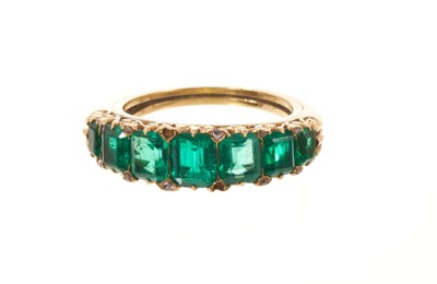 Lot Victorian emerald seven stone half hoop ring with seven graduated emeralds with rose cut diamond accents to the claws, in carved gold setting on tapered gold shank, ring size I.