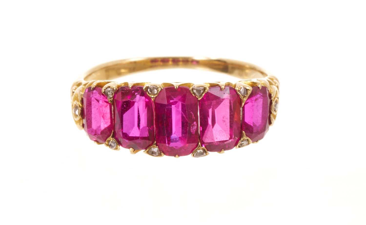 Lot 558 - Victorian ruby five stone half hoop ring with five graduated rubies with rose cut diamond accents to the claws, in carved gold setting on tapered shank, ring size J½.