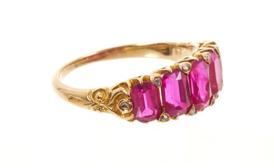 Lot 558 - Victorian ruby five stone half hoop ring with five graduated rubies with rose cut diamond accents to the claws, in carved gold setting on tapered shank, ring size J½.