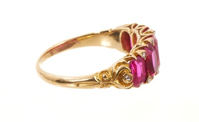 Lot 558 - Victorian ruby five stone half hoop ring with five graduated rubies with rose cut diamond accents to the claws, in carved gold setting on tapered shank, ring size J½.