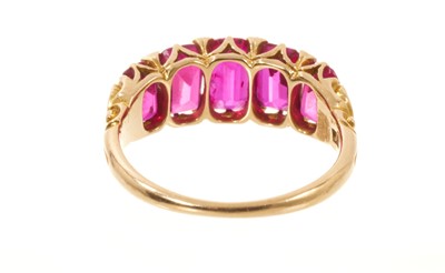 Lot 558 - Victorian ruby five stone half hoop ring with five graduated rubies with rose cut diamond accents to the claws, in carved gold setting on tapered shank, ring size J½.