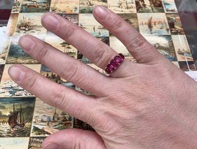 Lot 558 - Victorian ruby five stone half hoop ring with five graduated rubies with rose cut diamond accents to the claws, in carved gold setting on tapered shank, ring size J½.