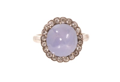 Lot Edwardian star sapphire and diamond cluster ring with a cabochon star sapphire measuring approximately 10.2mm x 9.6mm x 7.25mm, surrounded by a border of old cut diamonds in millegrain setting o...
