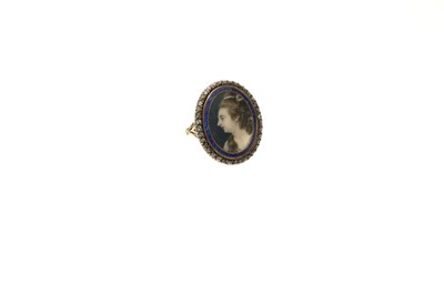 Lot George III ring with an oval portrait miniature on ivory depicting the bust of a young lady, with a blue guilloché enamel border, beneath a glazed bezel surrounded by a further border of old cu...