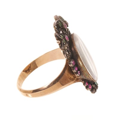 Lot 562 - Antique French ring with a portrait miniature on ivory depicting the bust of a young lady, the oval glazed bezel surmounted by pierced cresting and framed with diamonds, rubies and emeralds, on...