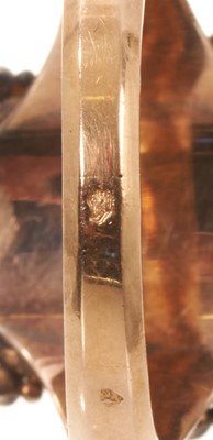 Lot 562 - Antique French ring with a portrait miniature on ivory depicting the bust of a young lady, the oval glazed bezel surmounted by pierced cresting and framed with diamonds, rubies and emeralds, on...