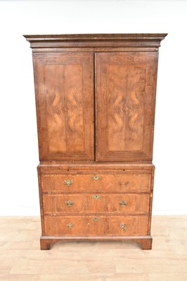 Lot Mid 18th century walnut crossbanded linen press, with cavetto moulded cornice and enclosed above by pair of door, the base with brushing slide and three long graduated drawers on bracket feet, 1...