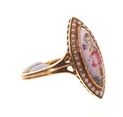Lot 563 - Victorian enamel and seed pearl ring, the navette shape enamel plaque depicting Cupid, with a seed pearl border, pierced gallery with trifurcated shoulders on reeded gold shank, ring size approx...