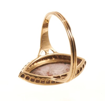 Lot 563 - Victorian enamel and seed pearl ring, the navette shape enamel plaque depicting Cupid, with a seed pearl border, pierced gallery with trifurcated shoulders on reeded gold shank, ring size approx...