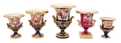 Lot Five 19th century Coalport porcelain urns, each painted with flowers, one of them on a maroon ground and the others on a cobalt blue ground, 12cm to 19cm high