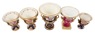 Lot 303 - Five 19th century Coalport porcelain urns, each painted with flowers, one of them on a maroon ground and the others on a cobalt blue ground, 12cm to 19cm high