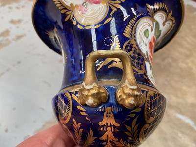 Lot 303 - Five 19th century Coalport porcelain urns, each painted with flowers, one of them on a maroon ground and the others on a cobalt blue ground, 12cm to 19cm high