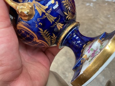 Lot 303 - Five 19th century Coalport porcelain urns, each painted with flowers, one of them on a maroon ground and the others on a cobalt blue ground, 12cm to 19cm high