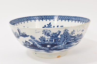 Lot 322 - Lowestoft blue and white punch bowl, circa 1775, printed to the exterior with figures in a Chinese island landscape, with further similar landscape vignettes, the interior with floral sprays and...