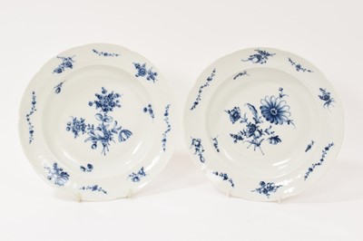 Lot 323 - Two 18th century Furstenberg porcelain shallow plates, painted with floral sprays and swags, the edge moulded with scrollwork cartouches, underglaze blue 'F' mark to bases, 23.75c diameter