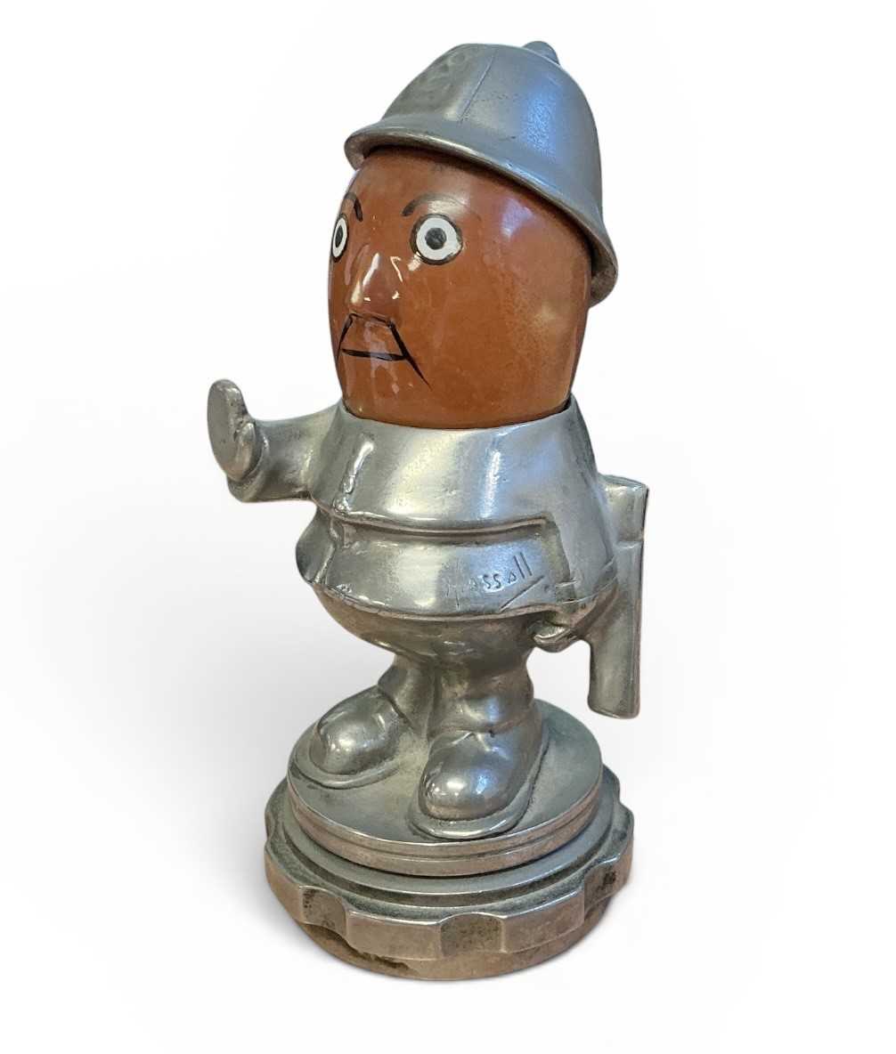 Lot 48 - Early 20th century 'Bobby' Policeman car mascot, with moving ceramic head, signed Hassall, mounted on a radiator cap, 14cm in overall height