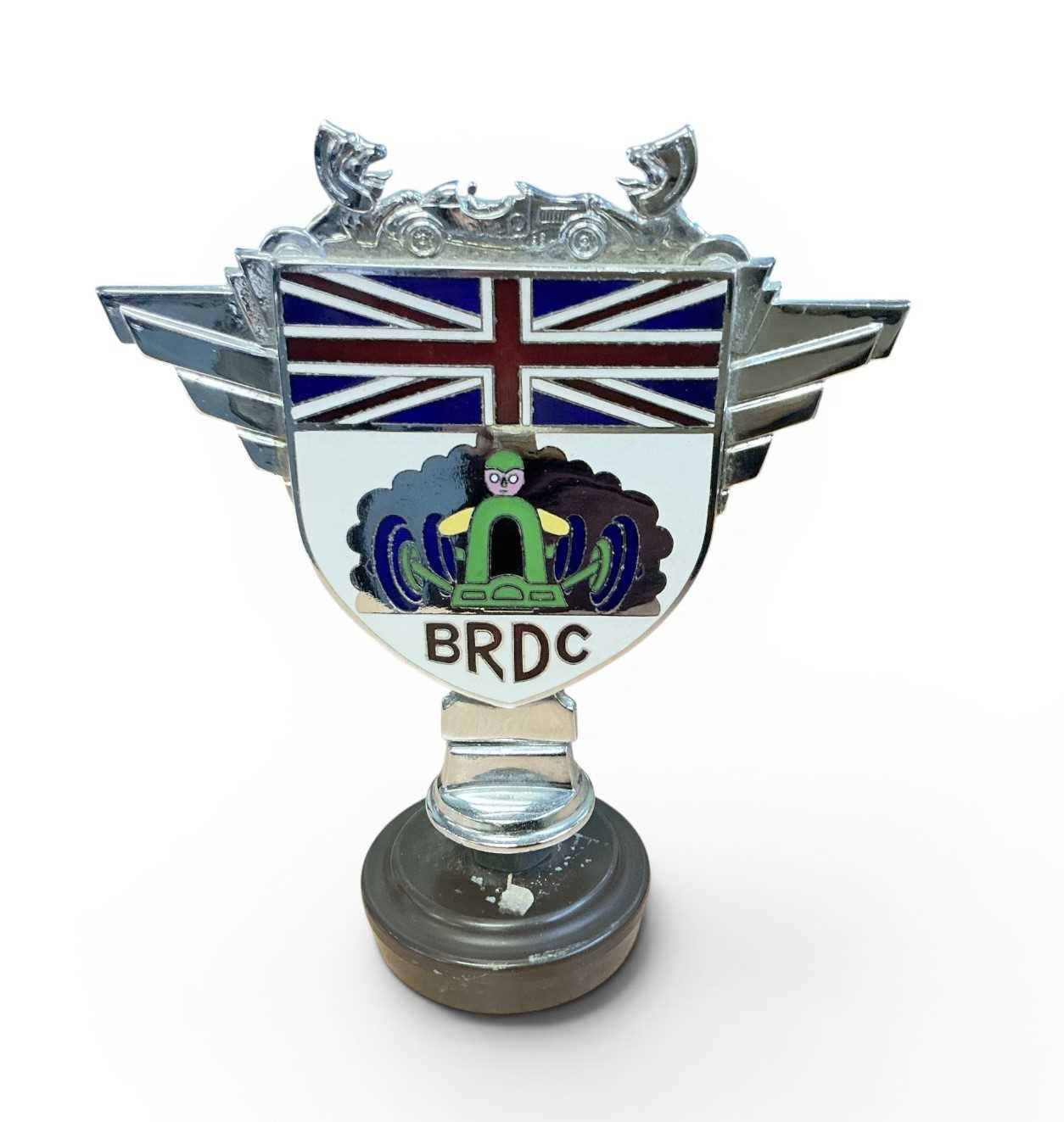 Lot 50 - British Racing Drivers' Club (BRDC) chromium and enamel members' car badge, stamped Collins, London to reverse, later mounted on a plastic stand, 12.5cm in overall height (excluding stand)