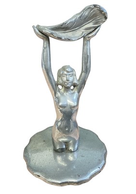 Lot 54 - Vintage car mascot in the form of a nude woman raising a feather aloft, on a radiator cap, 18cm in overall height
