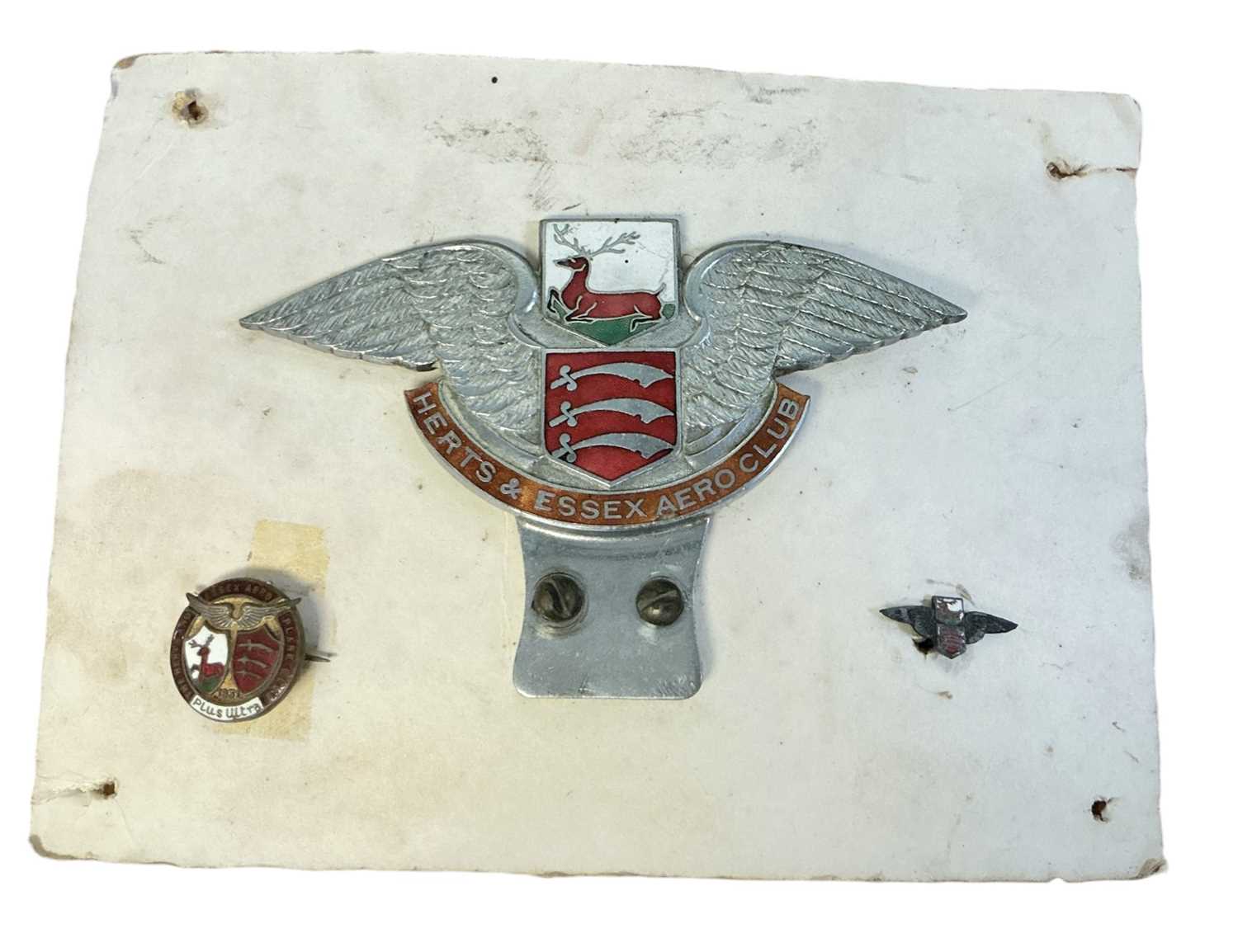 Lot 64 - Scarce Herts & Essex Aero Club chromium and enamel car badge, together with a pin badge dated 1931 and one other badge (3)