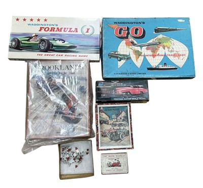 Lot 100 - Collection of vintage motoring related games and toys to include A JR Lady Penelope's FAB 1, jigsaw puzzle, cigarette cards and maps (1 box)