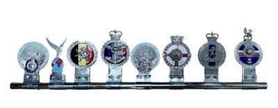 Lot 116 - Group of eight assorted military related car grill badges, mounted on a badge bar, to include RAF, Royal West Kent Regiment and Royal Navy