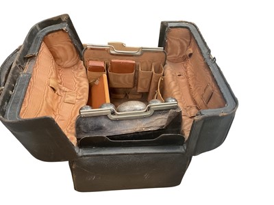 Lot 223 - Gladstone bag containing silver topped vanity jars etc.