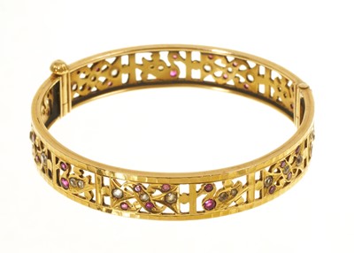 Lot 461 - Indian yellow metal and synthetic gem-set bangle