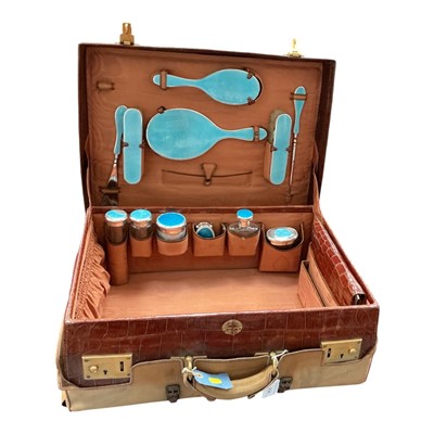 Lot 258 - Early 20th century crocodile skin travelling case with silver mounted and blue enamel fittings
