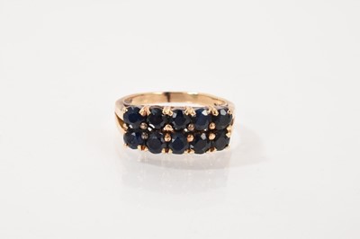 Lot 428 - Sapphire double row ring in gold setting