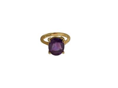 Lot 90 - Amethyst single stone ring with an oval mixed cut amethyst in four claw setting on 18ct yellow gold shank, size L½