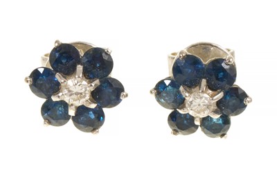 Lot 448 - Pair of sapphire and diamond flower head cluster earrings