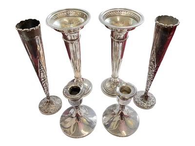 Lot 84 - Pair of late Victorian silver spill vases with embossed foliate scroll decoration, another pair of silver spill vases and a pair for silver candlesticks