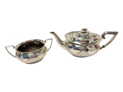 Lot 243 - Silver teapot and matching two handled sugar bowl