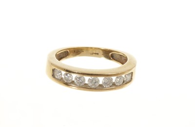 Lot 453 - Diamond eternity ring with a half hoop of seven brilliant cut diamonds in channel setting