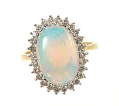 Lot Opal and diamond cluster ring with an oval cabochon opal surrounded by a brilliant cut diamonds in 18ct gold setting, London 1977