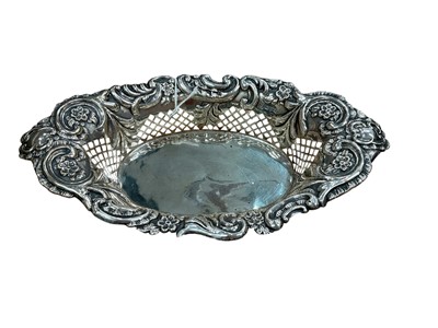 Lot 340 - Edwardian silver basket of oval form with pierced and embossed decoration (Chester 1907) George Nathan & Ridley Hayes. All at approximately 4.05ozs. 25.5cm across.