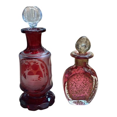 Lot 5076 - Victorian gilded cranberry scent bottle measuring 12cm tall together with a Bohemian red overlay hand engraved scent bottle measuring 16cm tall