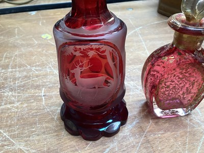 Lot 5076 - Victorian gilded cranberry scent bottle measuring 12cm tall together with a Bohemian red overlay hand engraved scent bottle measuring 16cm tall