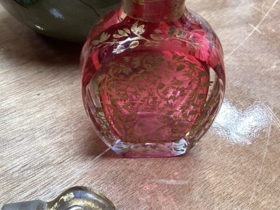 Lot 5076 - Victorian gilded cranberry scent bottle measuring 12cm tall together with a Bohemian red overlay hand engraved scent bottle measuring 16cm tall