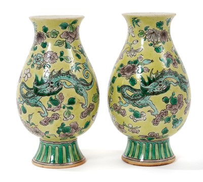 Lot 108 - Pair of Chinese famille jaune porcelain footed vases, Republic period, decorated with dragons amongst foliage, 12.5cm high