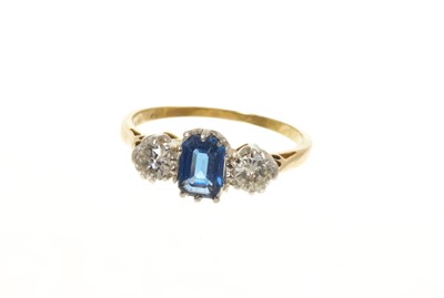 Lot 446 - Sapphire and diamond three stone ring with a rectangular cut-cornered blue sapphire flanked by two brilliant cut diamonds in claw setting on 18ct gold shank, estimated total diamond weight appro...