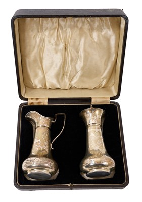 Lot 335 - Silver strawberry set comprising sugar caster and cream jug in a fitted case, all at 6.65ozs.
