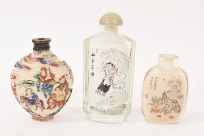 Lot 740 - 19th century Chinese famille rose enamelled snuff bottle, decorated in relief with the eight barbarians bearing tribute, seal mark to base, possibly 19th century, 8cm, together with two inside p...