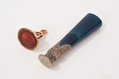 Lot 712 - 19th century yellow metal seal fob, with carnelian portrait intaglio, and a white metal desk seal with blue hardstone handle (2)