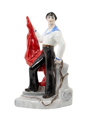 Lot 143 - Rare Russian Soviet period porcelain figure of a sailor, polychrome painted, modelled standing with a red flag and rope, inscribed title and impressed hammer and sickle mark to base
