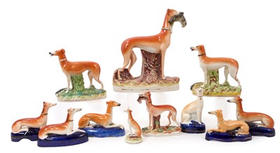Lot 137 - A pack of Victorian Staffordshire greyhounds, each with inscribed name to base, including inkwells and standing figures, 10.5cm to 28cm (11)